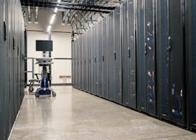 Modern data center corridor with server racks and computer equipment. Ideal for technology and IT concepts.